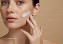 Close-Up of Freckled Woman Applying Skincare on Face