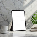 Modern tablet on marble desk with coffee and books