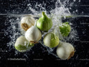 Fresh Garlic and Onion Bulbs Splashing into Water