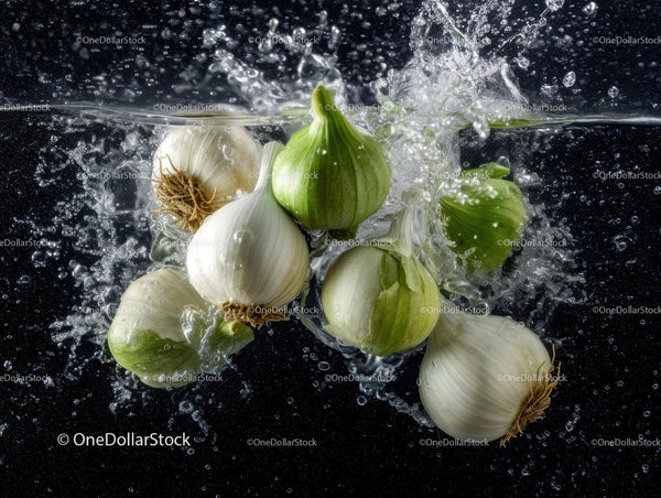 Fresh Garlic and Onion Bulbs Splashing into Water