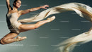 Graceful ballet dancer leaps with flowing fabric