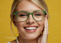 Smiling woman with green glasses and elegant pearls