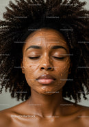 Young woman with curly hair relaxing with facial mask skincare