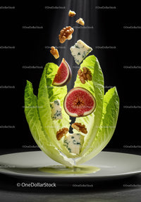 Fresh fig and blue cheese salad with walnuts on lettuce