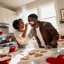 Couple Playfully Baking Heart Shaped Cookies Together