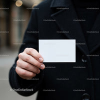 Person Holding Blank White Business Card Outdoors