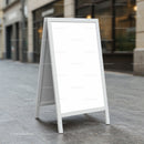 Blank White A-Frame Sign on Urban Sidewalk