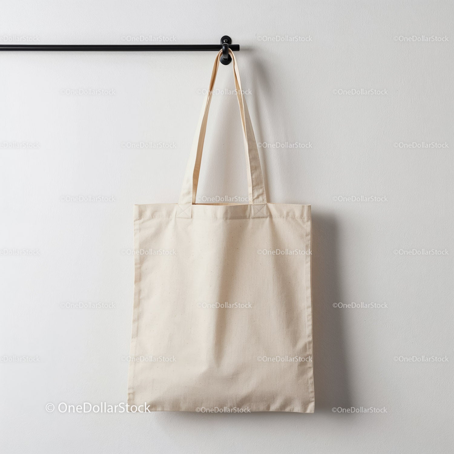 Minimalist natural cotton tote bag hanging on wall hook