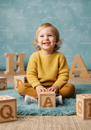 Toddler playing with wooden alphabet blocks indoors