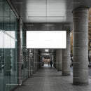 Urban walkway with modern columns and blank billboard