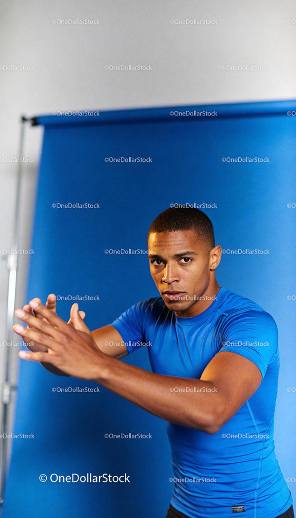 Focused athlete warming up with intense hand stretch