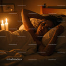 Woman Relaxing in Bed with Candles in a Cozy Atmosphere