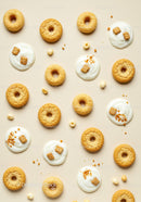 Assorted cookies and yogurt dollops on beige surface