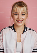 Cheerful Young Woman with Blonde Hair in Casual Jacket on Pink Background
