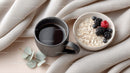 Coffee and Oatmeal with Berries on Cozy Fabric Background