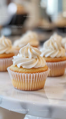 Vanilla Cupcakes with Creamy Frosting in a Bakery Setting