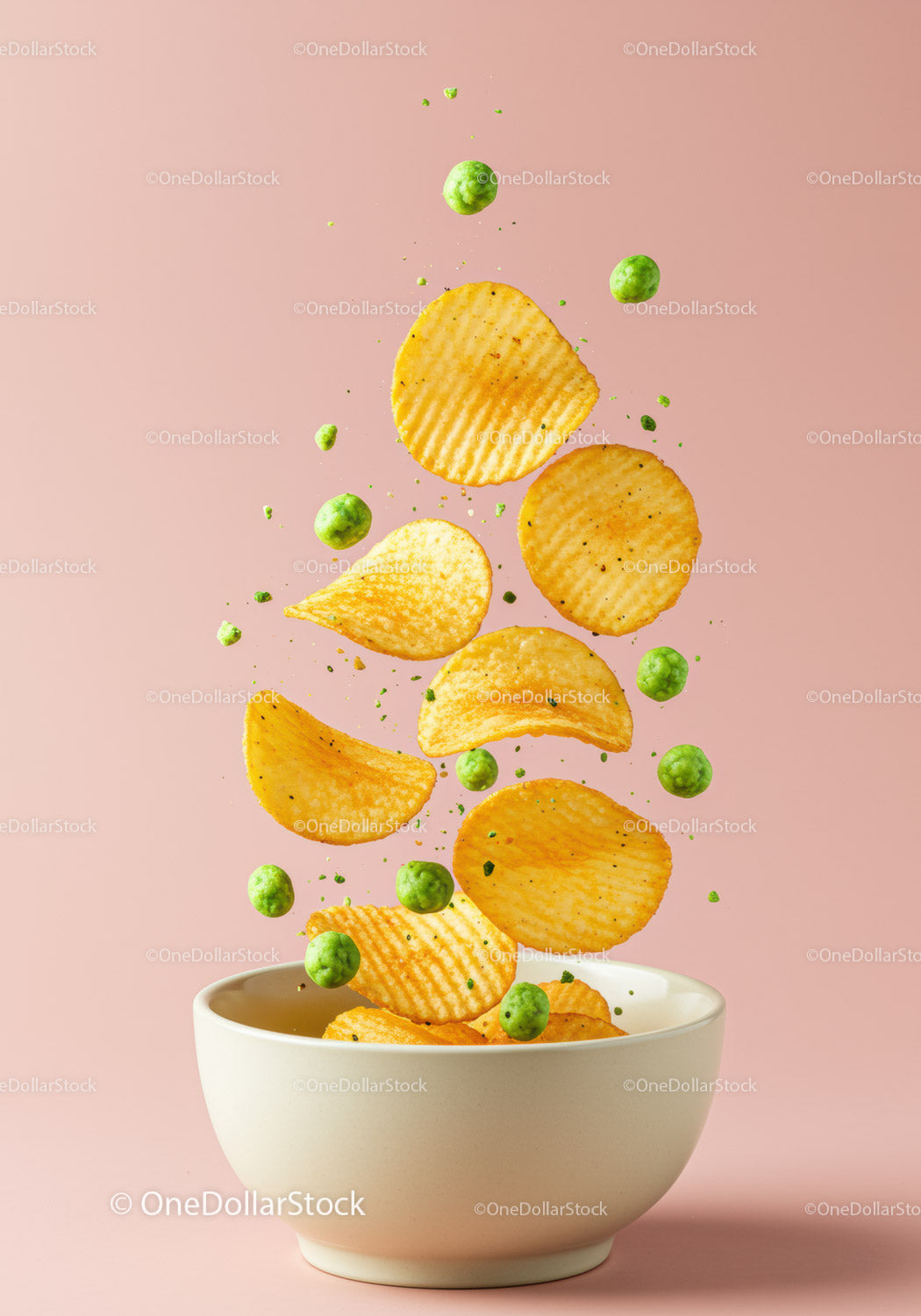 Crispy potato chips and green peas in bowl on pink