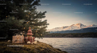 Christmas gifts and decorations near lake with snowy mountains