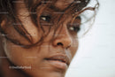 Close-up of a Woman with Wet Skin and Dark Curly Hair by the Ocean