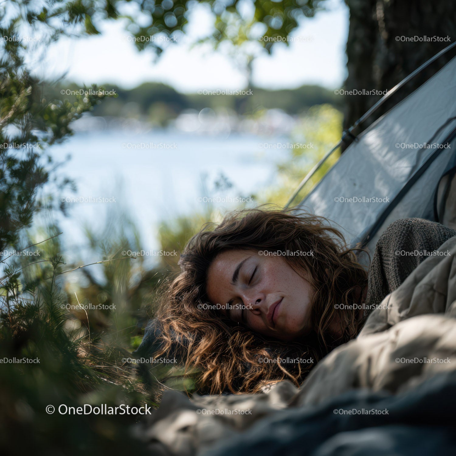 Peaceful Young Woman Sleeping by Tent in Natural Lakeside Setting