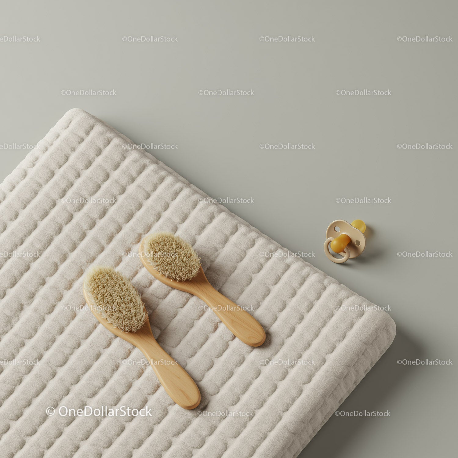 Soft baby brushes and pacifier on cushioned mat