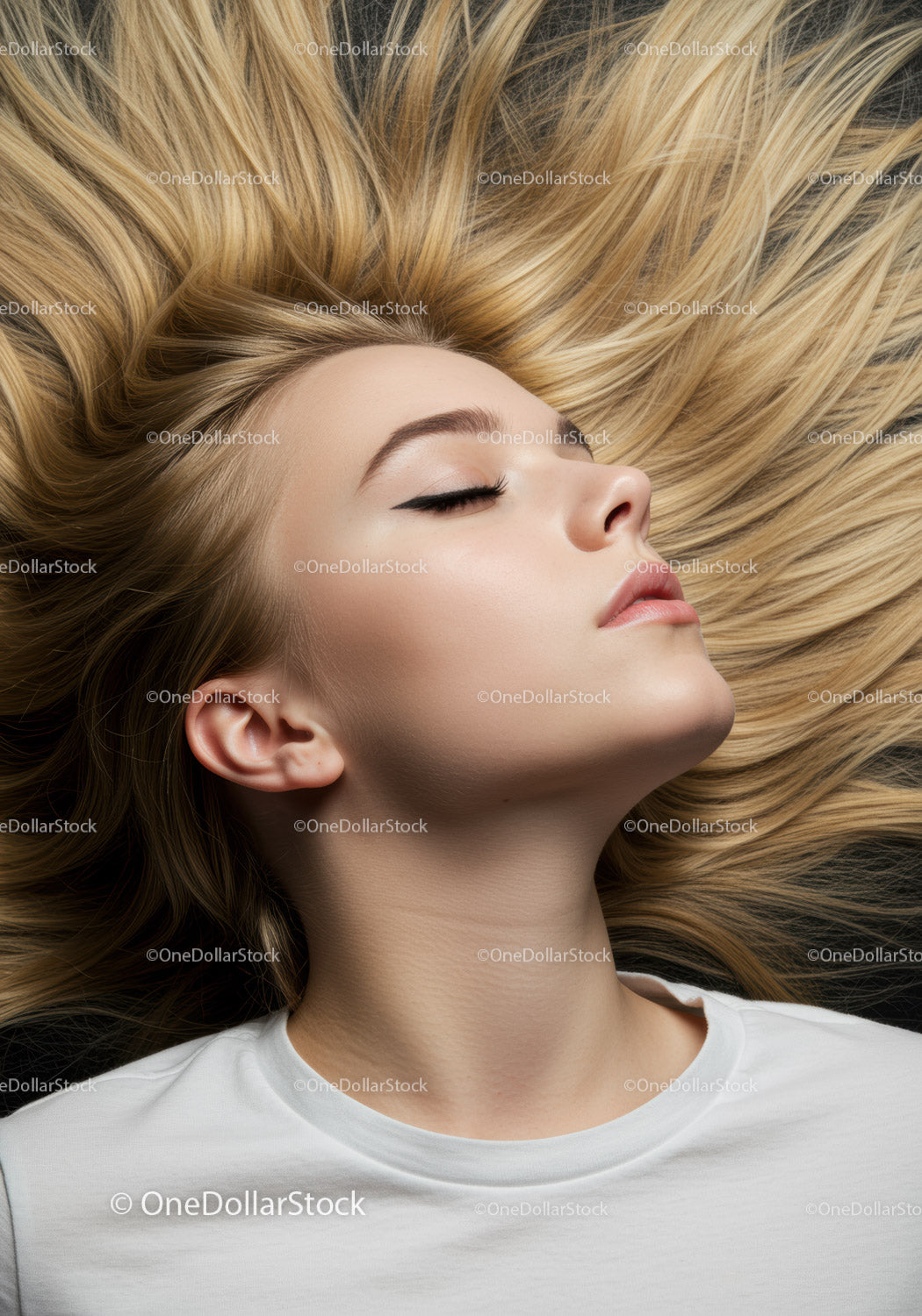 Calm young woman with flowing blonde hair lying down