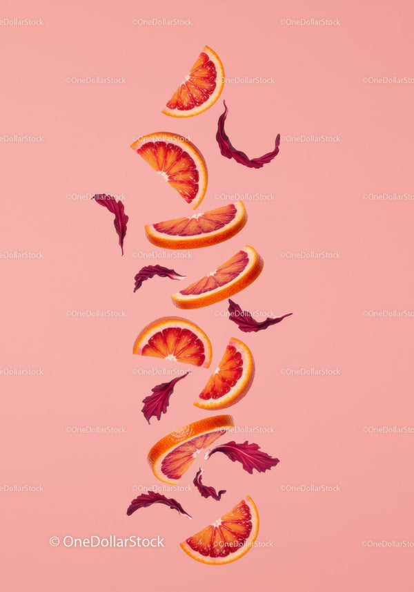 Floating Blood Orange Slices with Red Leaves on Pink