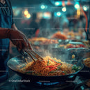 Street food vendor cooking stir-fry noodles at night market