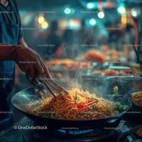 Street food vendor cooking stir-fry noodles at night market