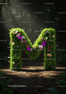 Green letter M covered with orchids in forest