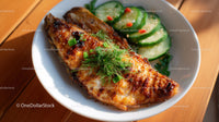 Grilled Fish with Cucumber Salad and Herbs in White Bowl