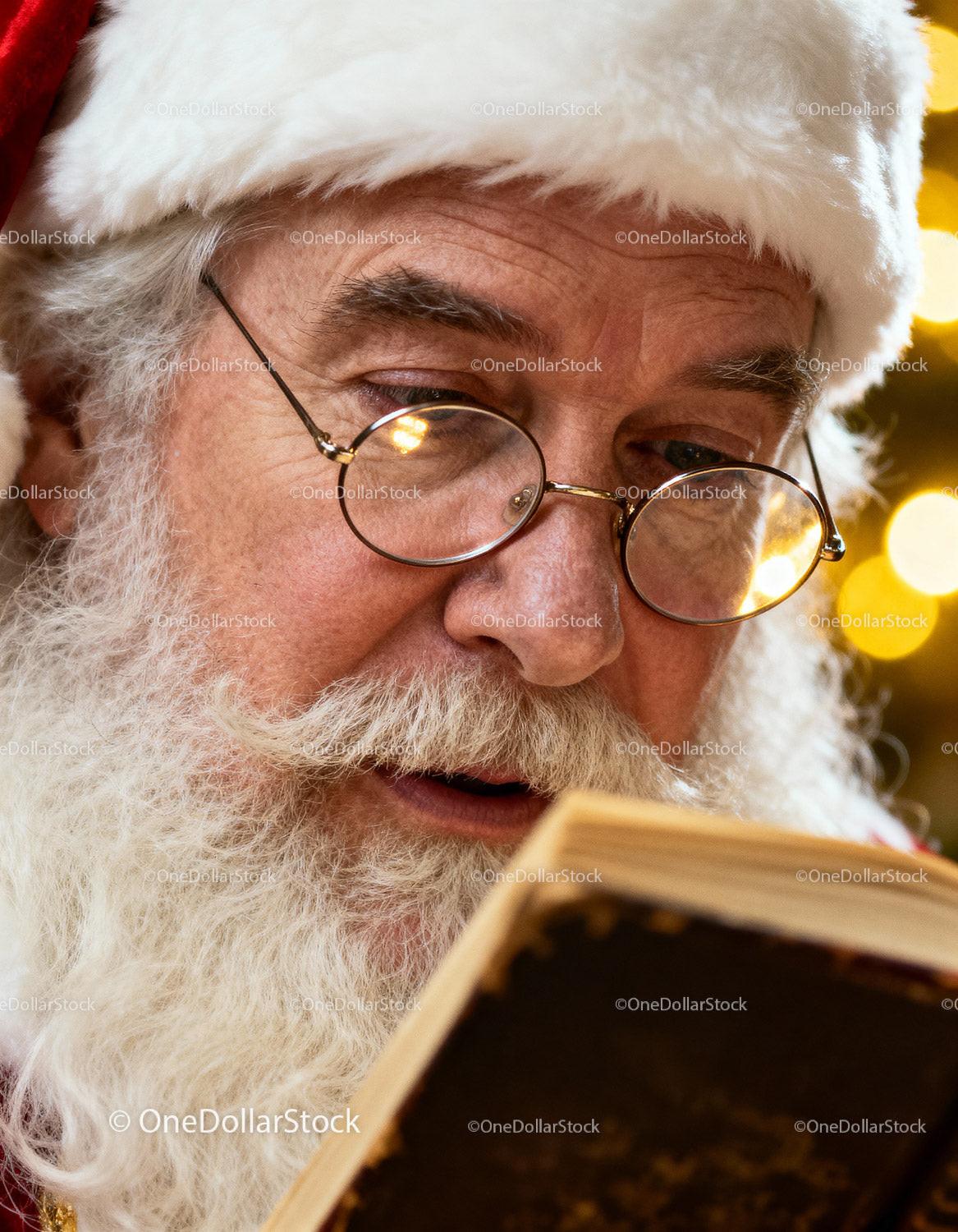Close up of Santa Claus reading an old book