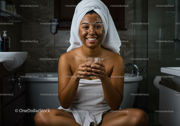 Happy Woman with Facial Mask and Towel in Bathroom Scene