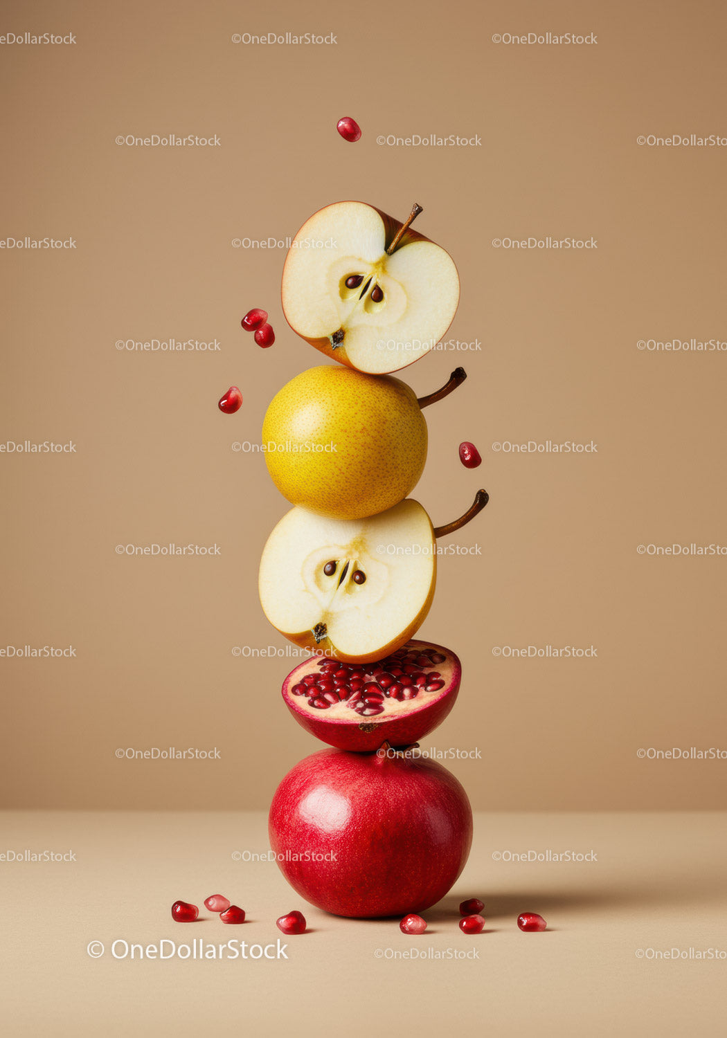 Balanced stack of apples and pomegranate with seeds