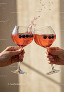 Two glasses clinking with sparkling berry cocktails