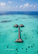 Overwater Bungalows on Turquoise Lagoon with Wooden Pier in Tropical Paradise