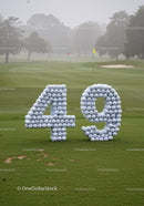 Number 49 formed with golf balls on green course