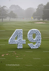 Number 49 formed with golf balls on green course