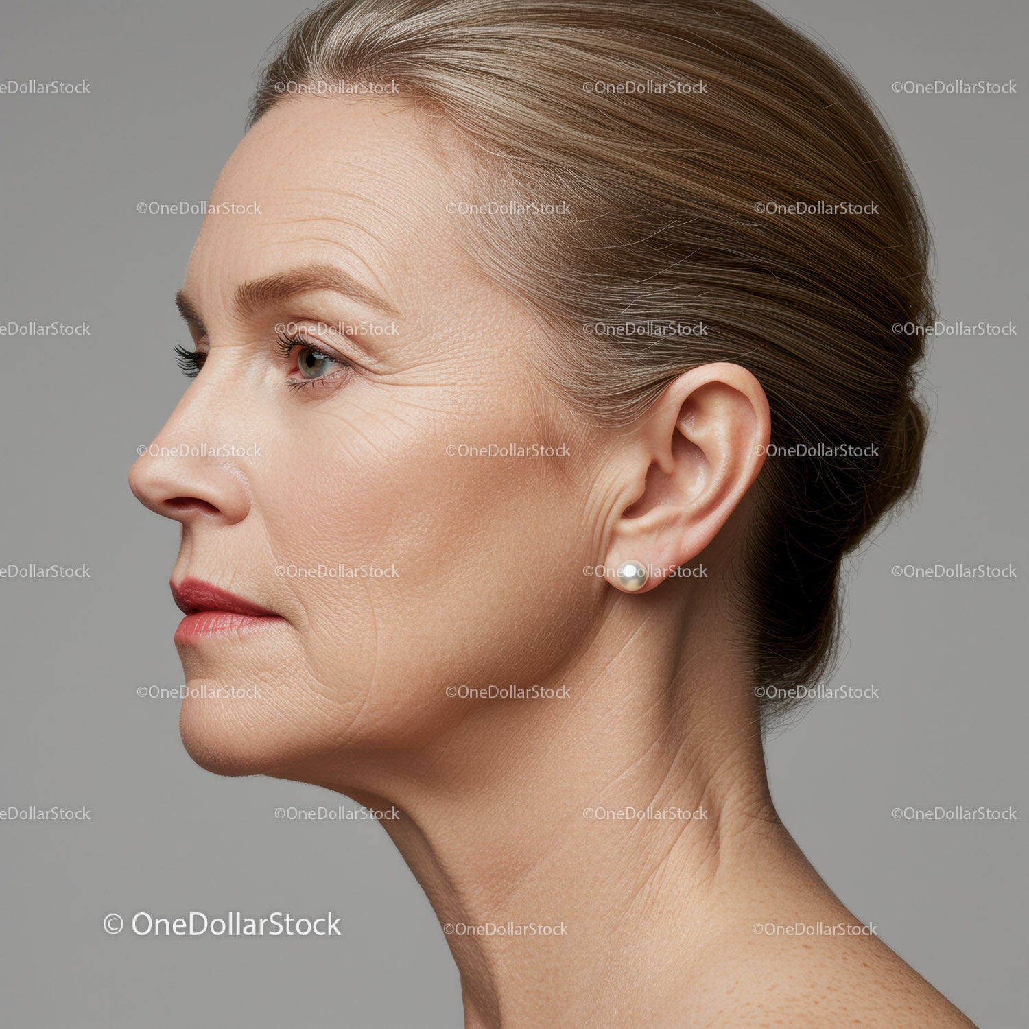 Elegant Mature Woman Side Profile with Flawless Skin and Pearl Earring