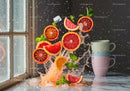 Fresh citrus slices splashing with ice and mint leaves