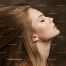 Profile of serene woman with flowing hair and closed eyes