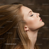 Profile of serene woman with flowing hair and closed eyes