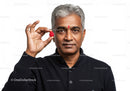 Professional Portrait of Mature Man with Gray Hair Holding Raspberry