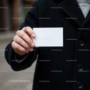 Person Holding Blank Business Card in Black Coat