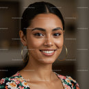 Smiling Young Woman with Floral Top and Hoop Earrings