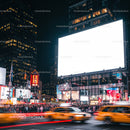 Busy urban street with bright billboards at night