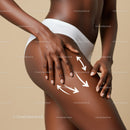 Close-up of a Woman's Toned Thigh with Hands Touching Skin in Neutral Setting