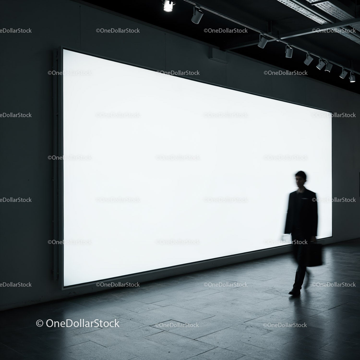 Silhouetted businessman walking past bright billboard
