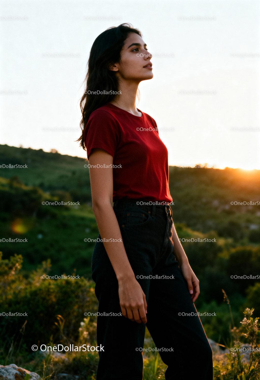 Young woman standing thoughtfully in sunset landscape