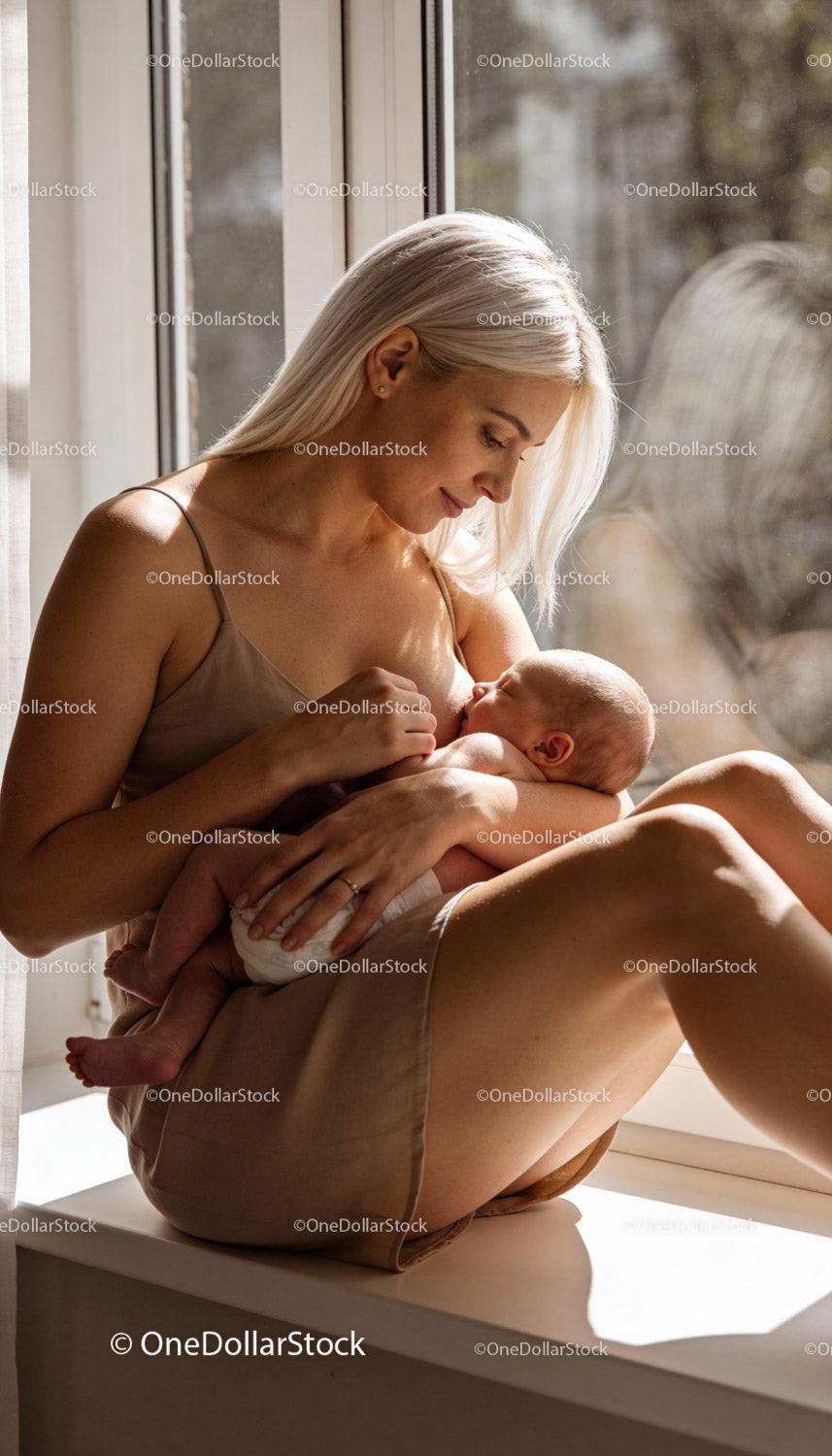 Mother Breastfeeding Newborn in Warm Natural Light